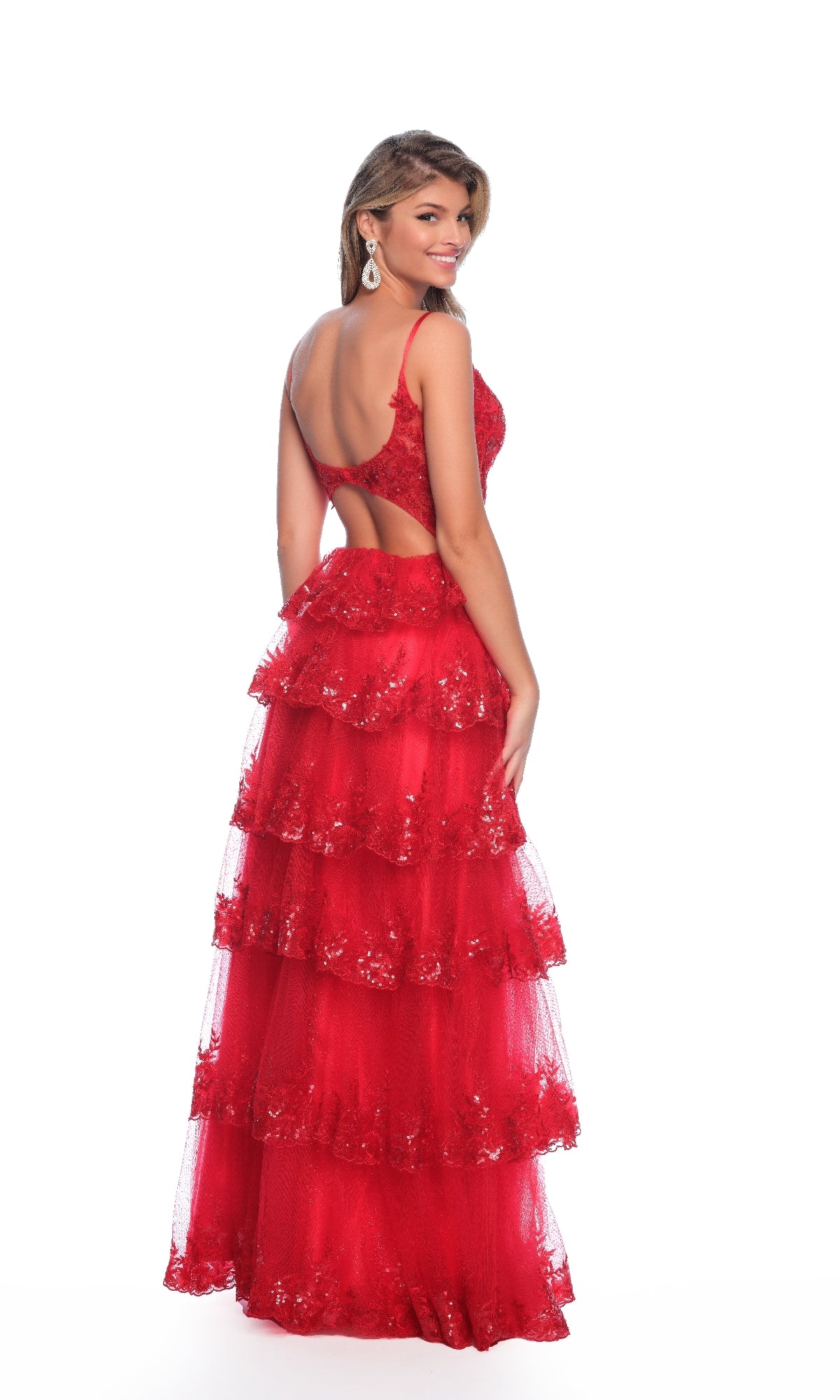Woman in a sleeveless red lace A-line gown with a sweetheart neckline and open back, smiling against a white background—elegant Dave and Johnny 12051 Red Prom Dress.